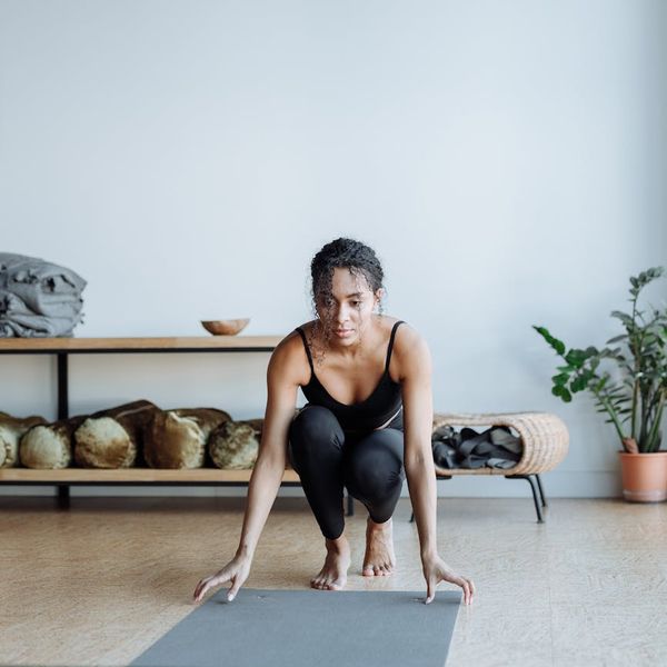 Person holding a challenging balance yoga pose with focused determination.